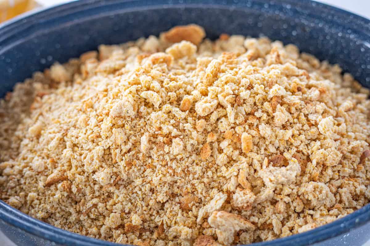 Breadcrumbs being shown in a large blue roasting dish. 