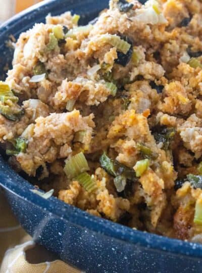 cornbread stuffing in a blue roasting pan.