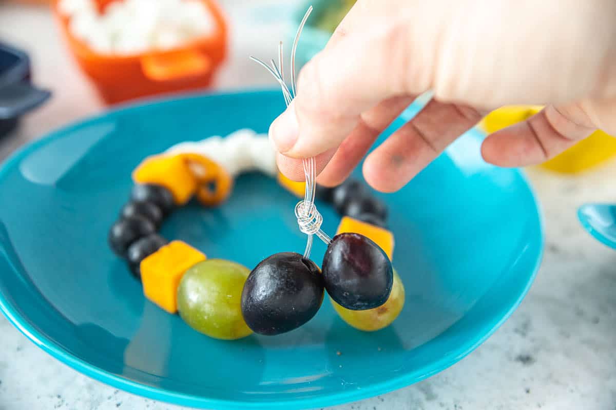 A necklace with snacks being tied. 