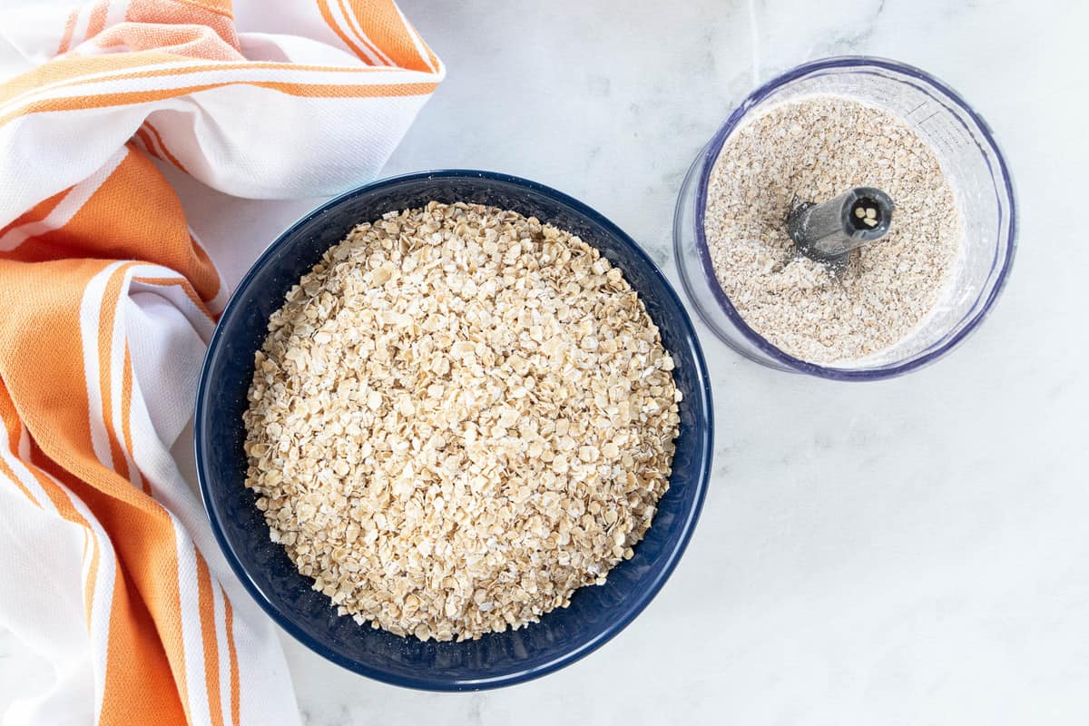 A bowl of oats and a small food processor filled with pureed oats.