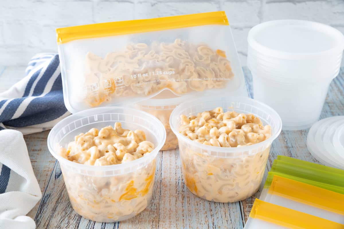 Plastic containers filled with Mac and cheese ready to be frozen.