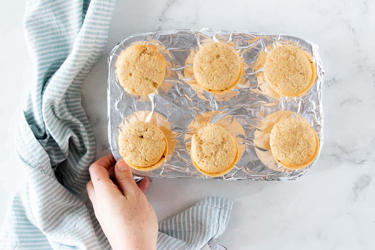 Ice cream cone cupcakes that have been baked in a tinfoil lined muffin tin. 