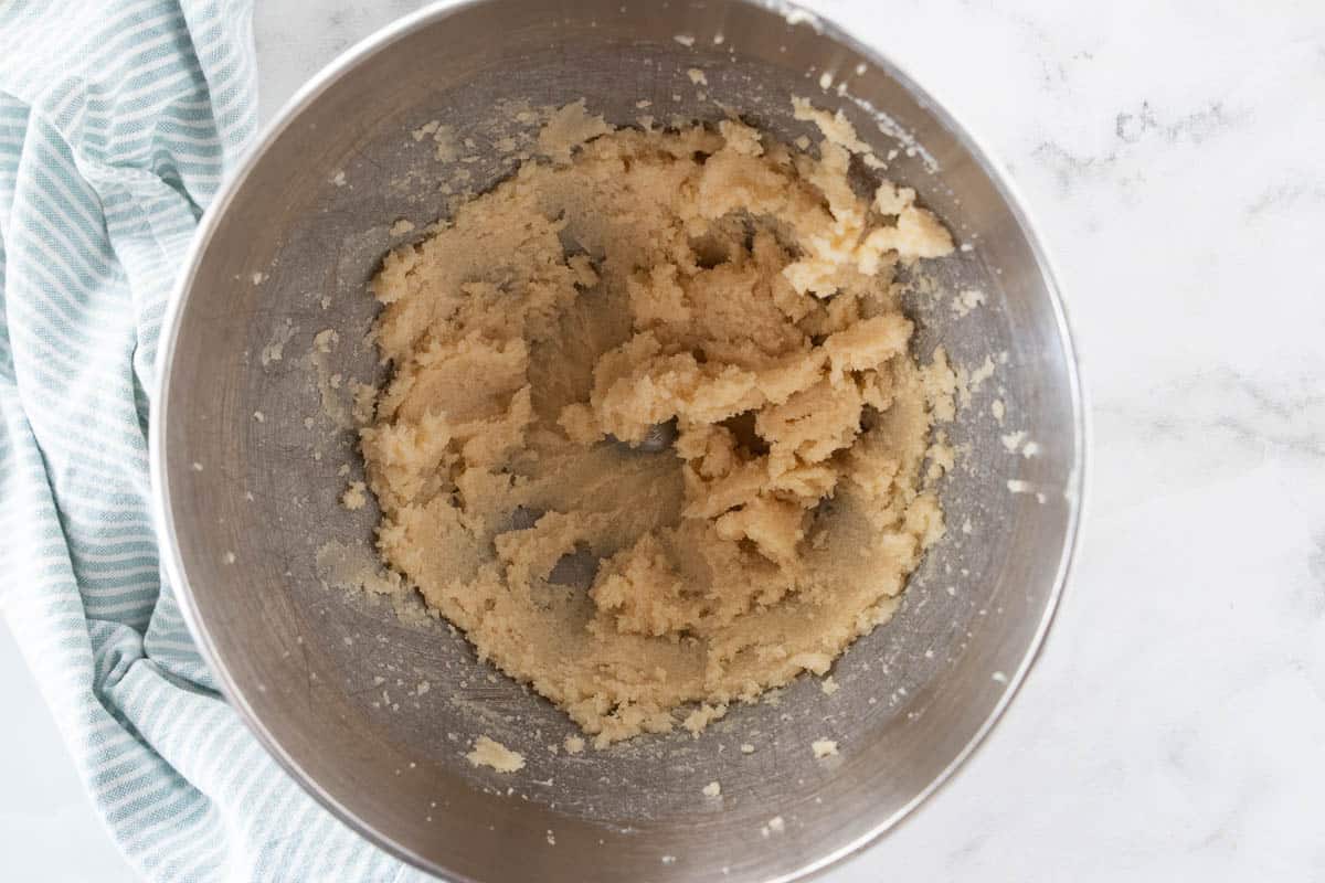 Cupcake batter being shown in a mixing bowl. 