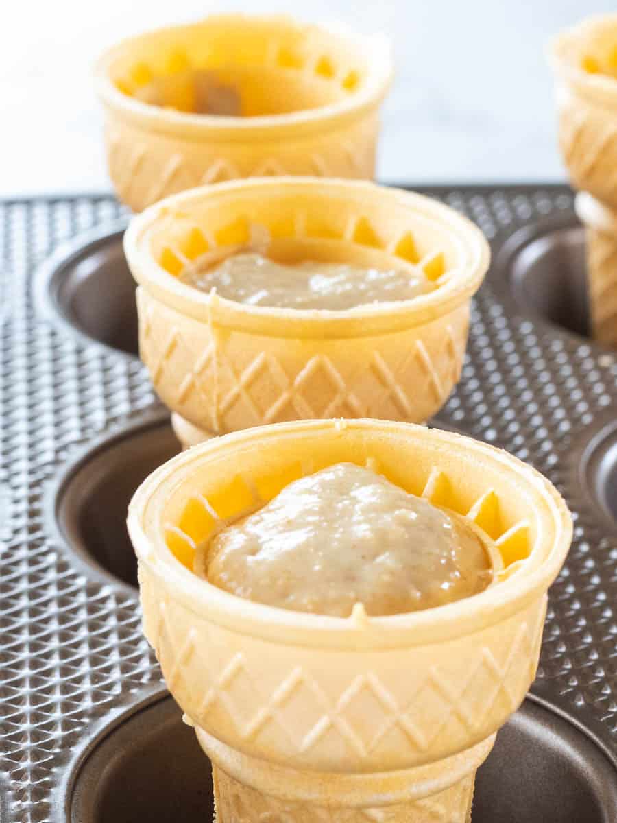 Ice cream cone cupcakes being shown in a muffin tin.