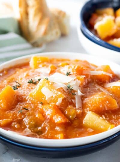 slow cooker chunky vegetable soup in a bowl with parmesan cheese