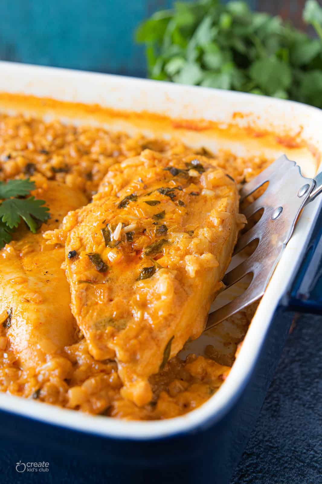 rice casserole serving being scooped from pan