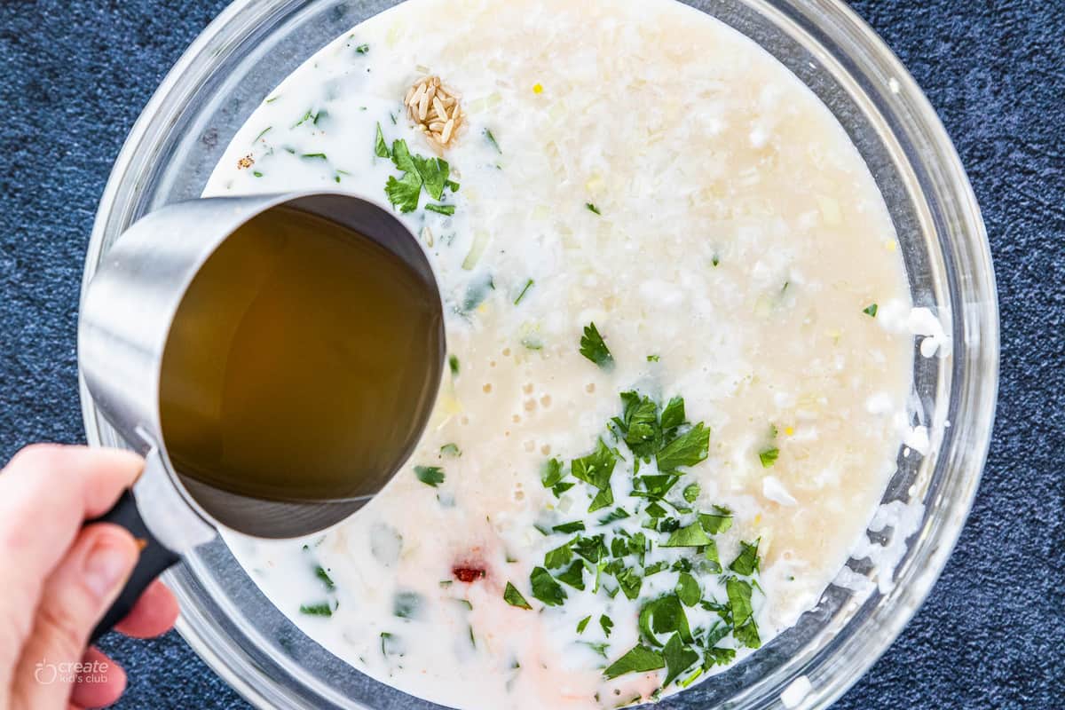 ingredients being poured into a mixing bowl