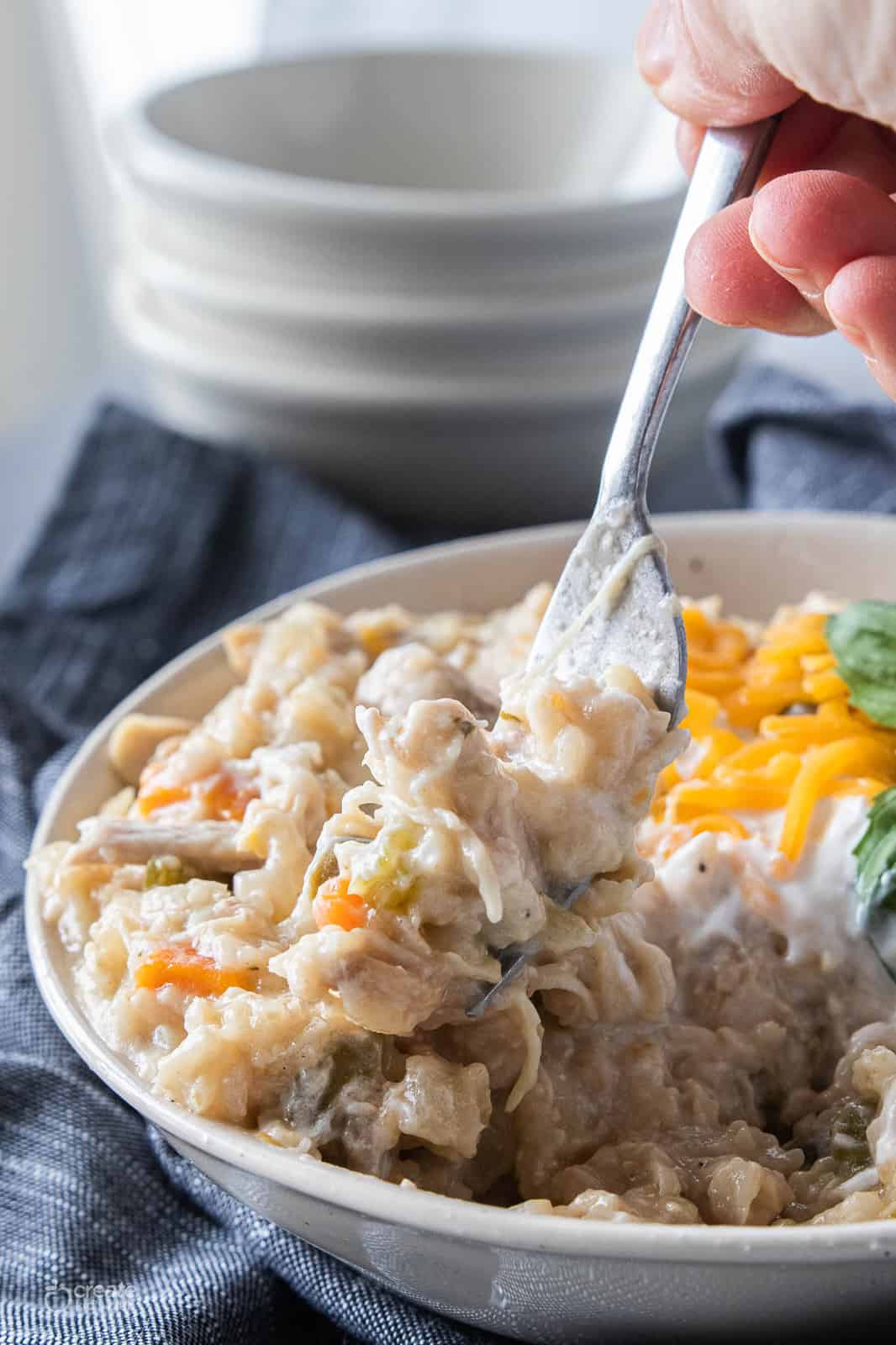 chicken and rice in a bowl with a fork