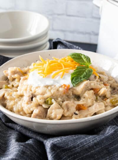 chicken and rice in a bowl with sour cream on top