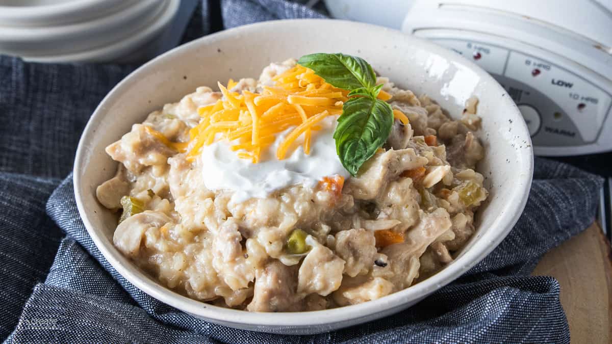 crock pot recipe chicken and rice in a bowl topped with cheese
