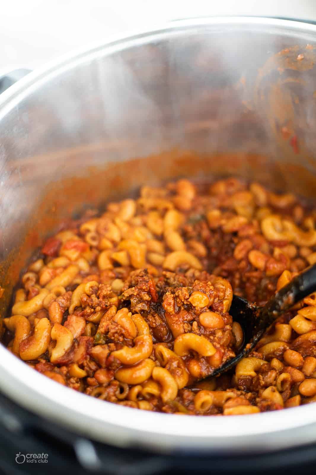 chili mac being scooped from the instant pot