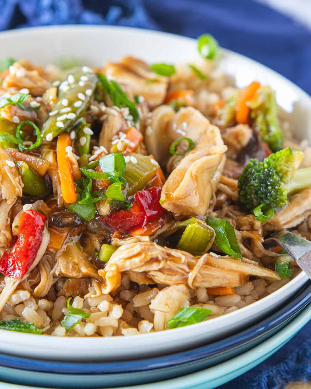 instant pot chicken stir fry on top of a bed of rice in a bowl. 