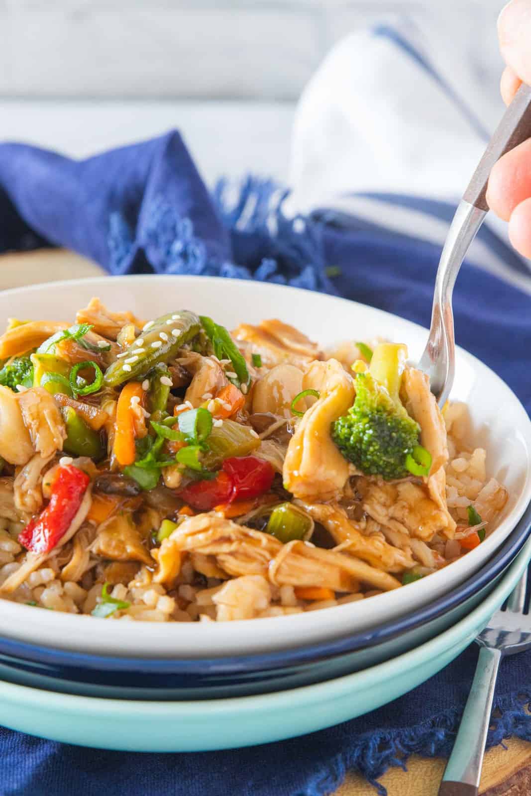 instant pot chicken stir fry in a bowl with a fork