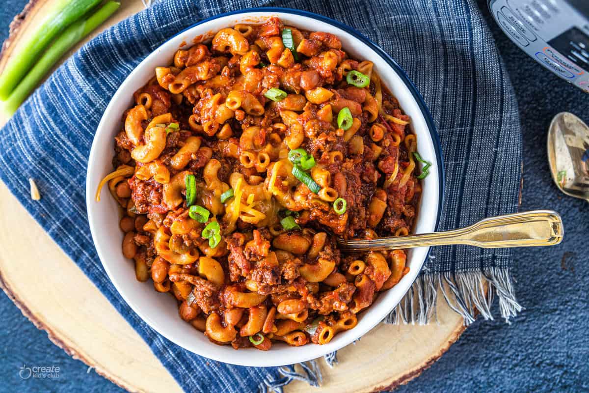 instant pot chili mac in a bowl with a fork