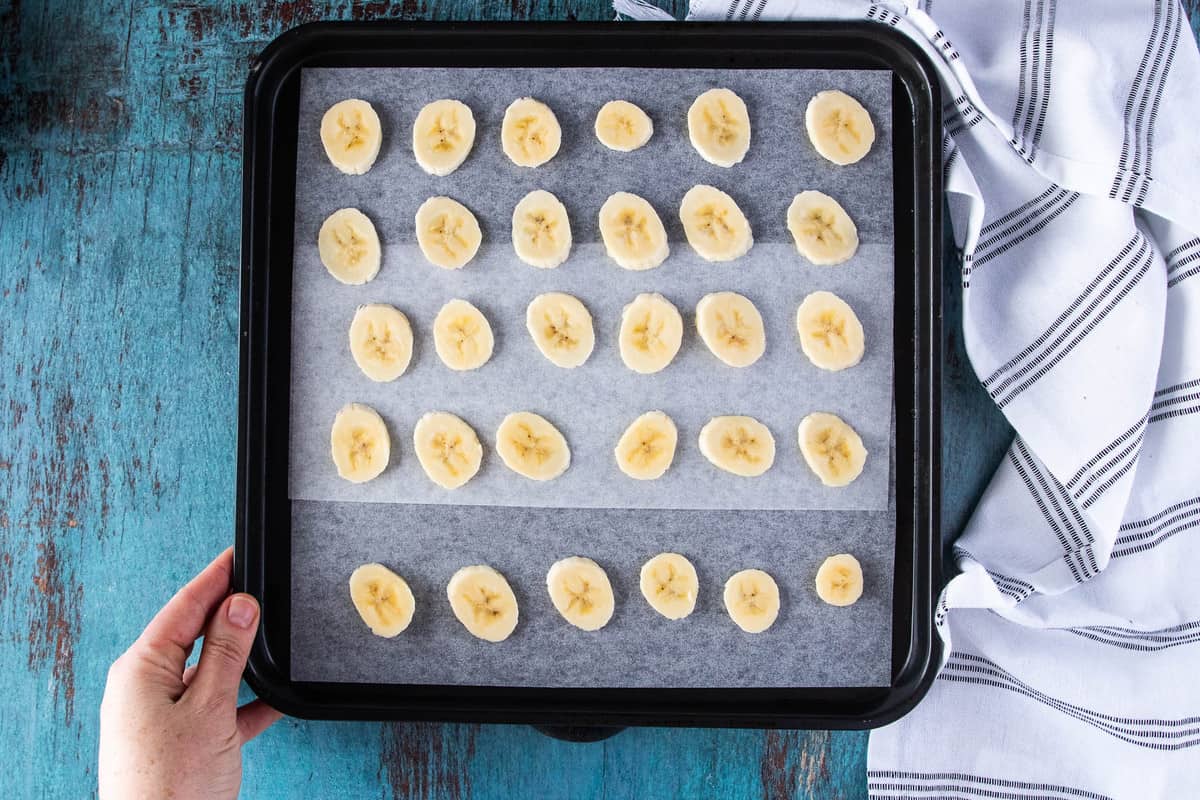 banana slices on parchment lined tray