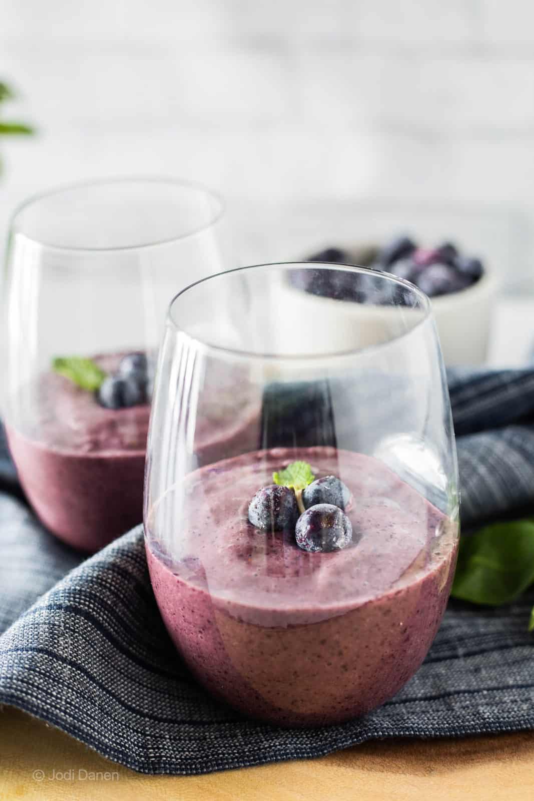 blueberry spinach smoothie in drinking glasses
