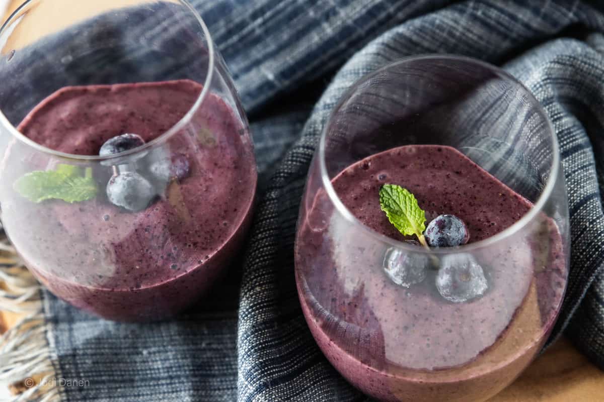 two smoothies in drinking glasses