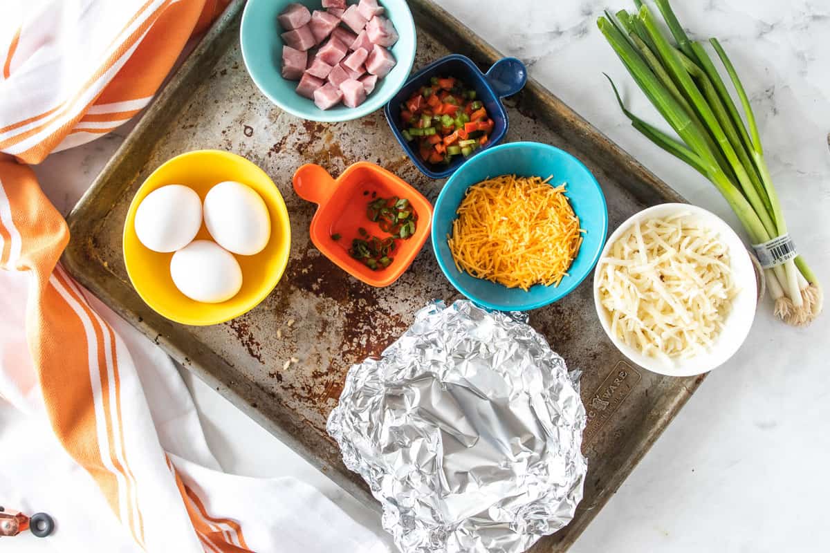 ingredients on a baking sheet for a breakfast bowl.