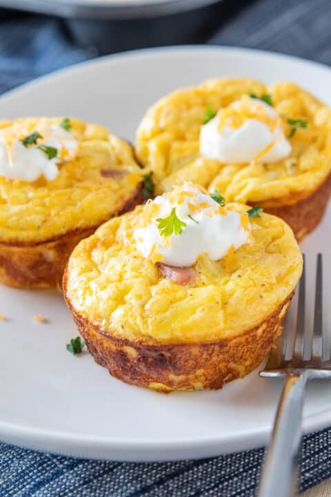 three hash brown egg cups on a plate