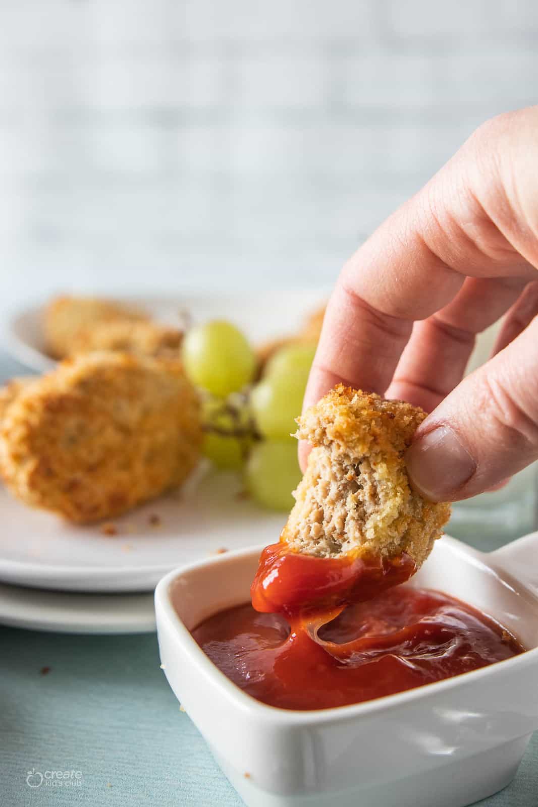 homemade chicken nugget dipped in ketchup