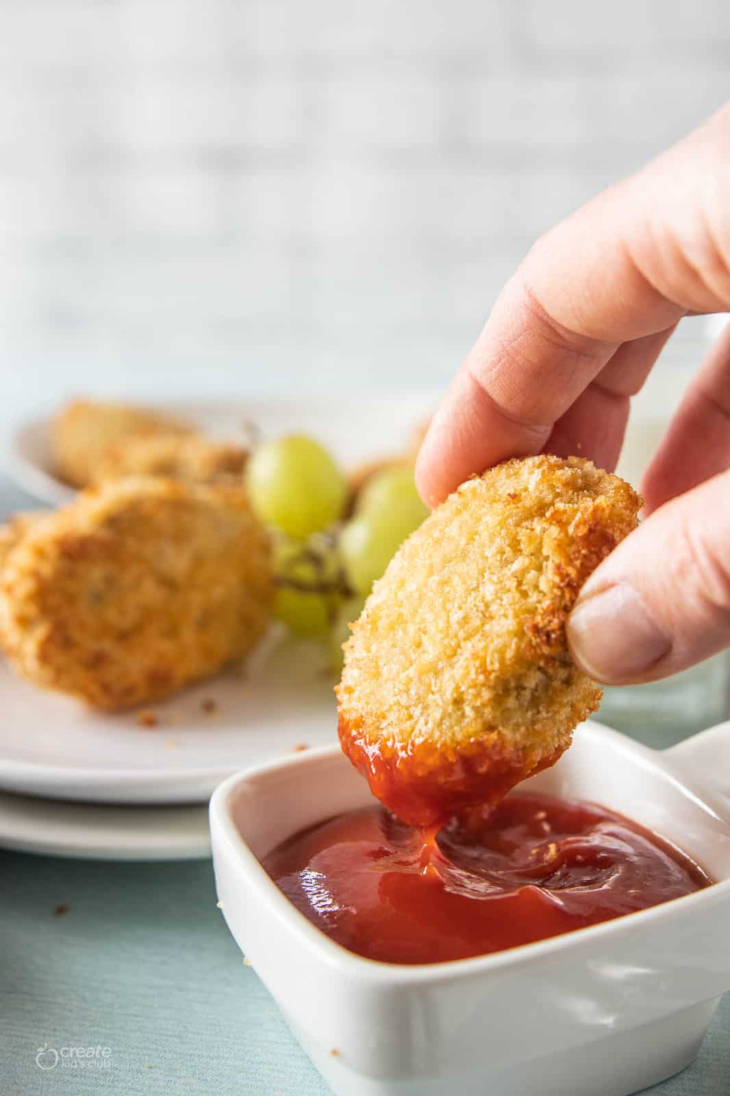 homemade chicken nugget dipped in ketchup