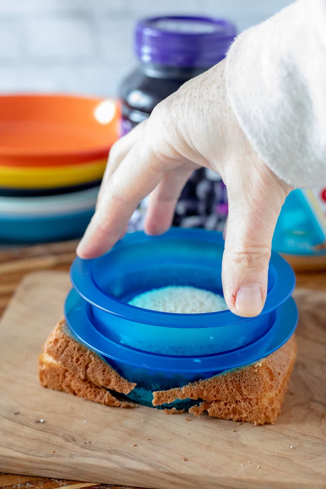 hand cutting sandwich with an uncrustable cutter