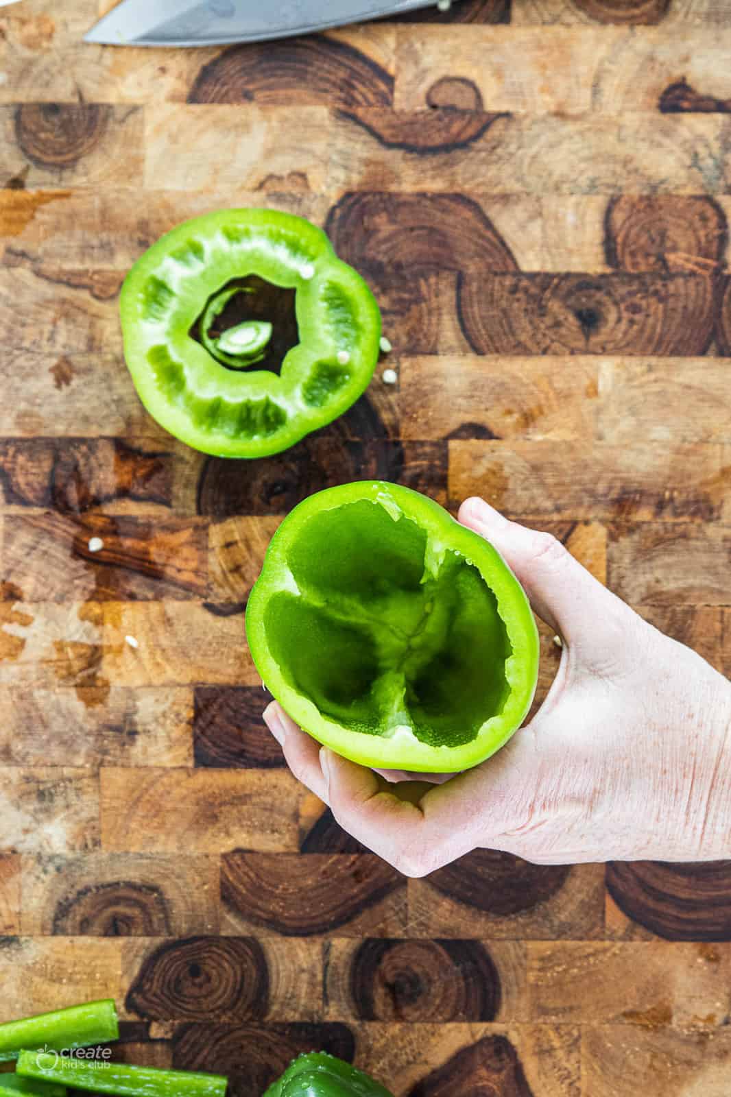 green bell pepper with top stem portion sliced and removed