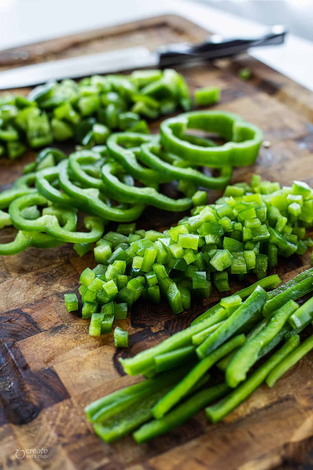 julienne cut, diced and bell pepper rings on a cutting board