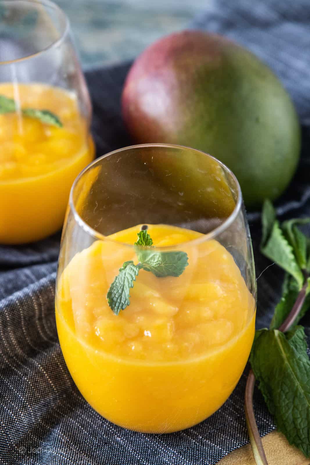 mango slushie in drinking glasses