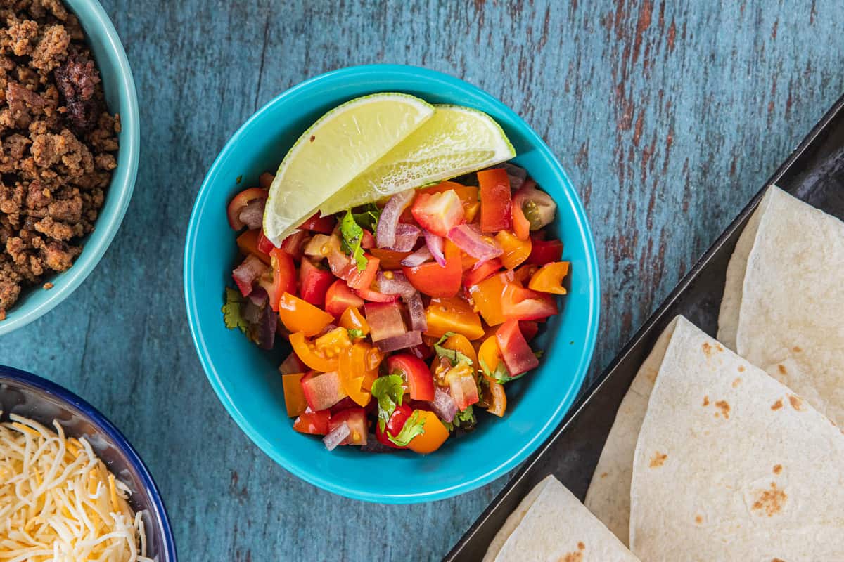 diced tomatoes, peppers and onions with lime slices