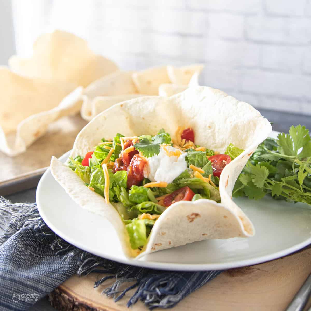 homemade taco shell bowl with taco ingredients 