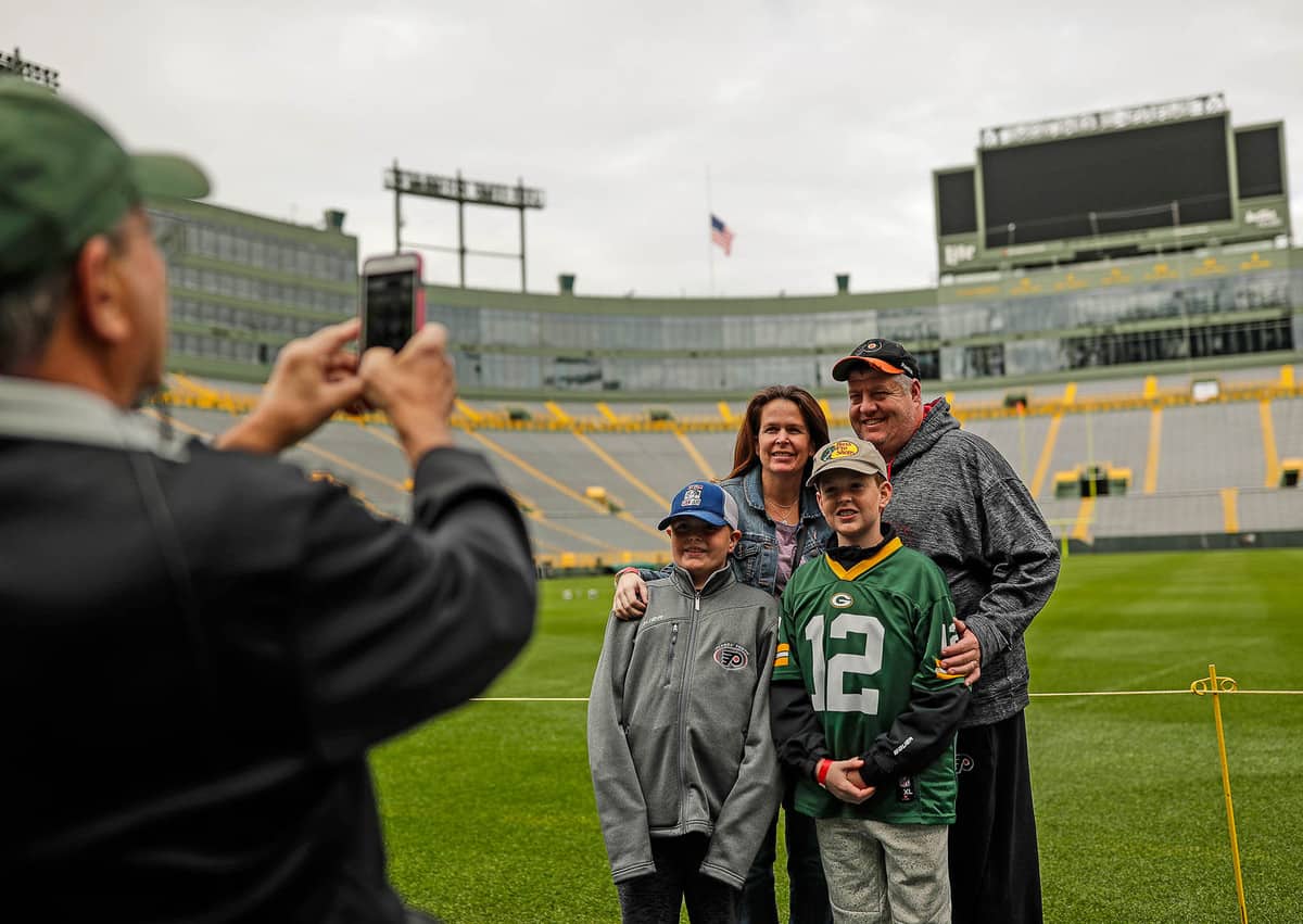 family taking a photo at Lambeau Field Stadium