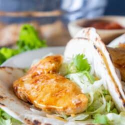 chicken tenderloins and shredded lettuce in taco shell