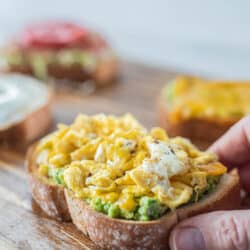 avocado toast topped with scrambled eggs