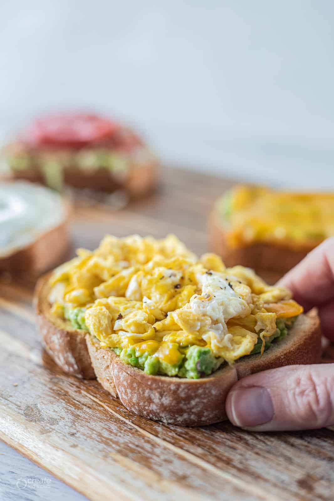 avocado toast topped with scrambled eggs