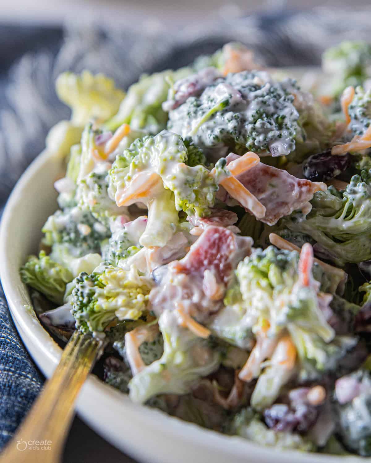 Broccoli salad in serving bowl with a spoon