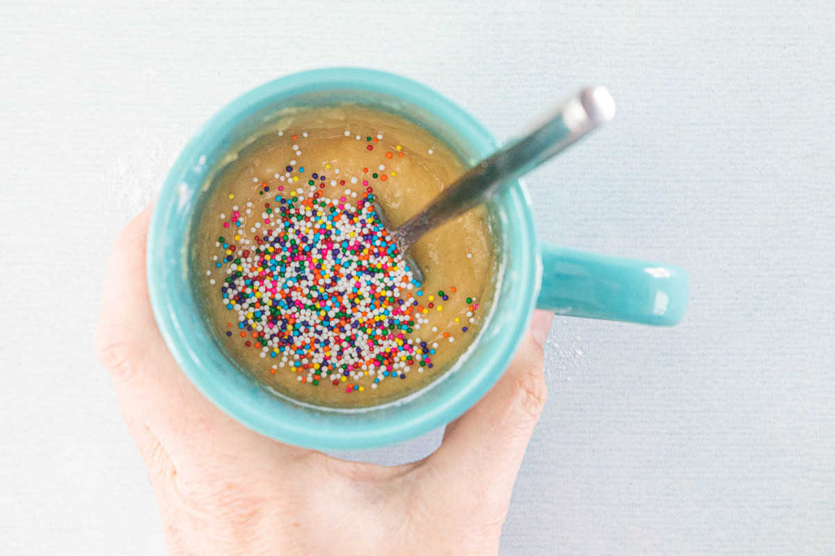 cake batter and sprinkles in a mug