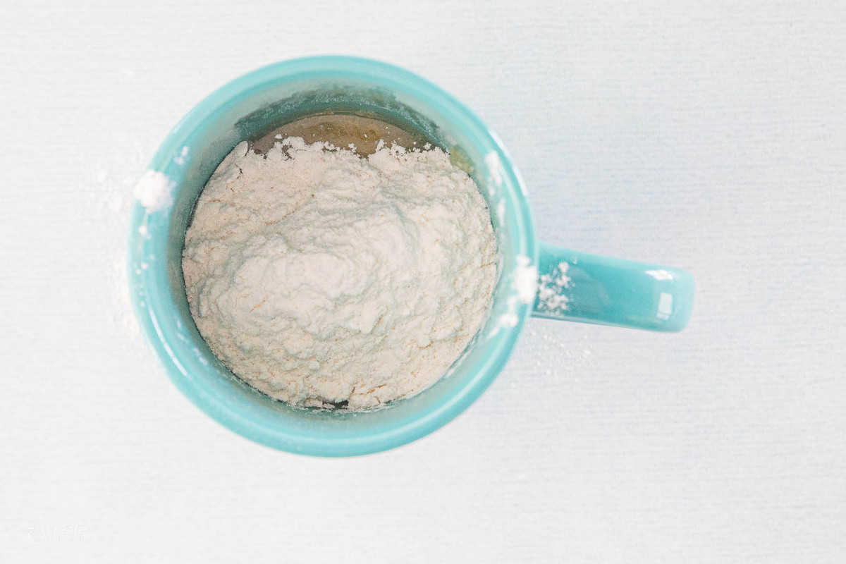 flour in mug with an egg