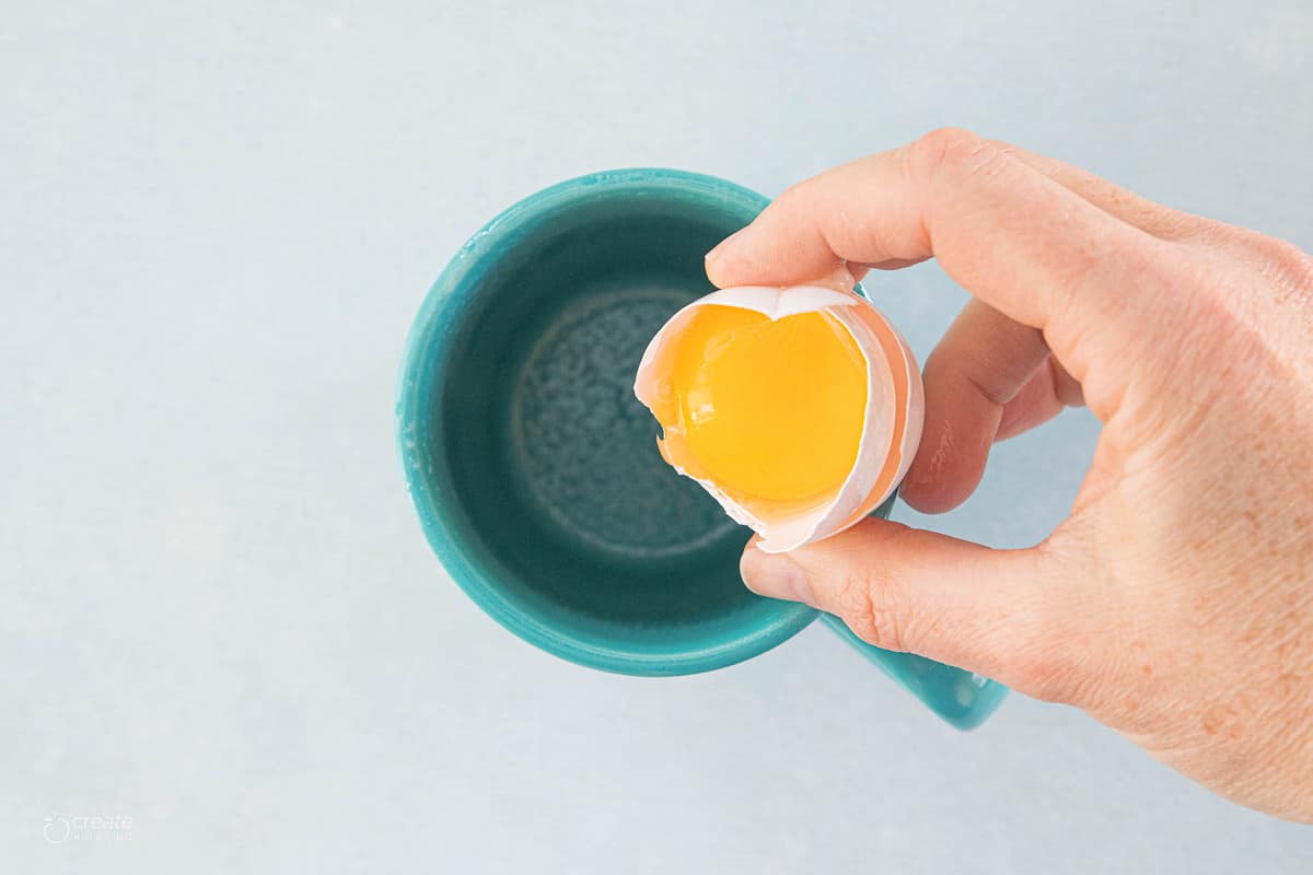 egg yolk being added to a mug