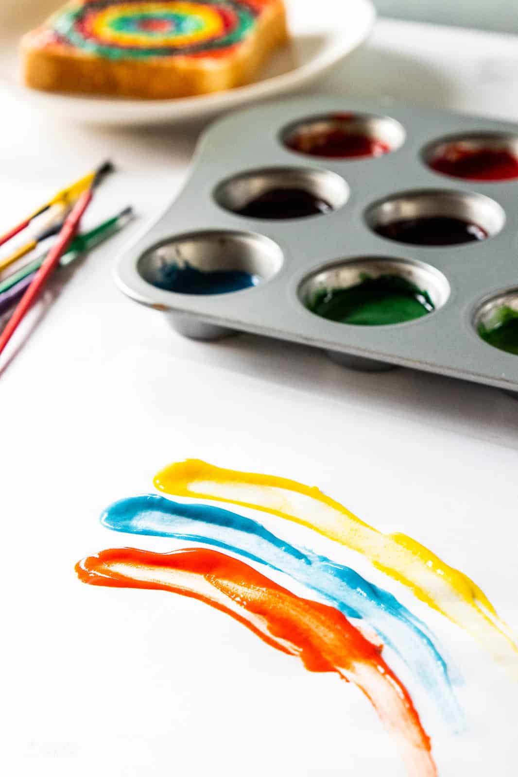 finger paint in muffin tin and spread on paper 