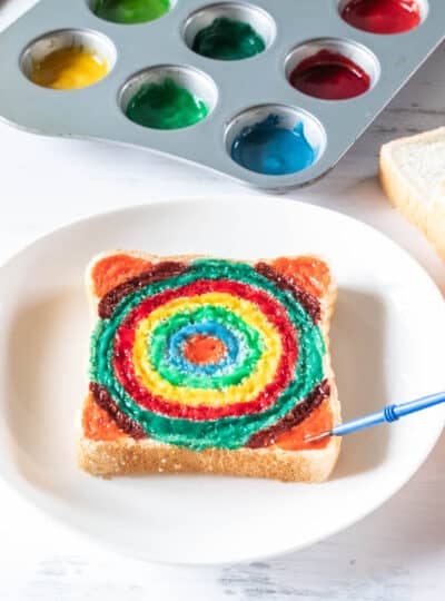 slice of bread being painted with edible paint