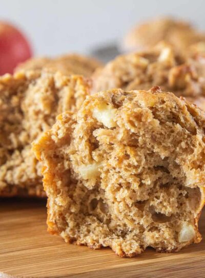 An apple muffin broken in half.