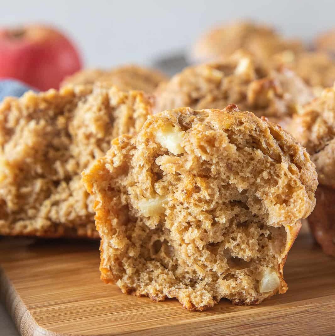 An apple muffin broken in half.