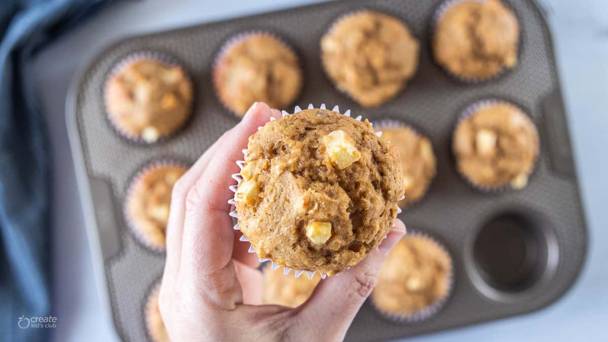 hand holding an apple muffin