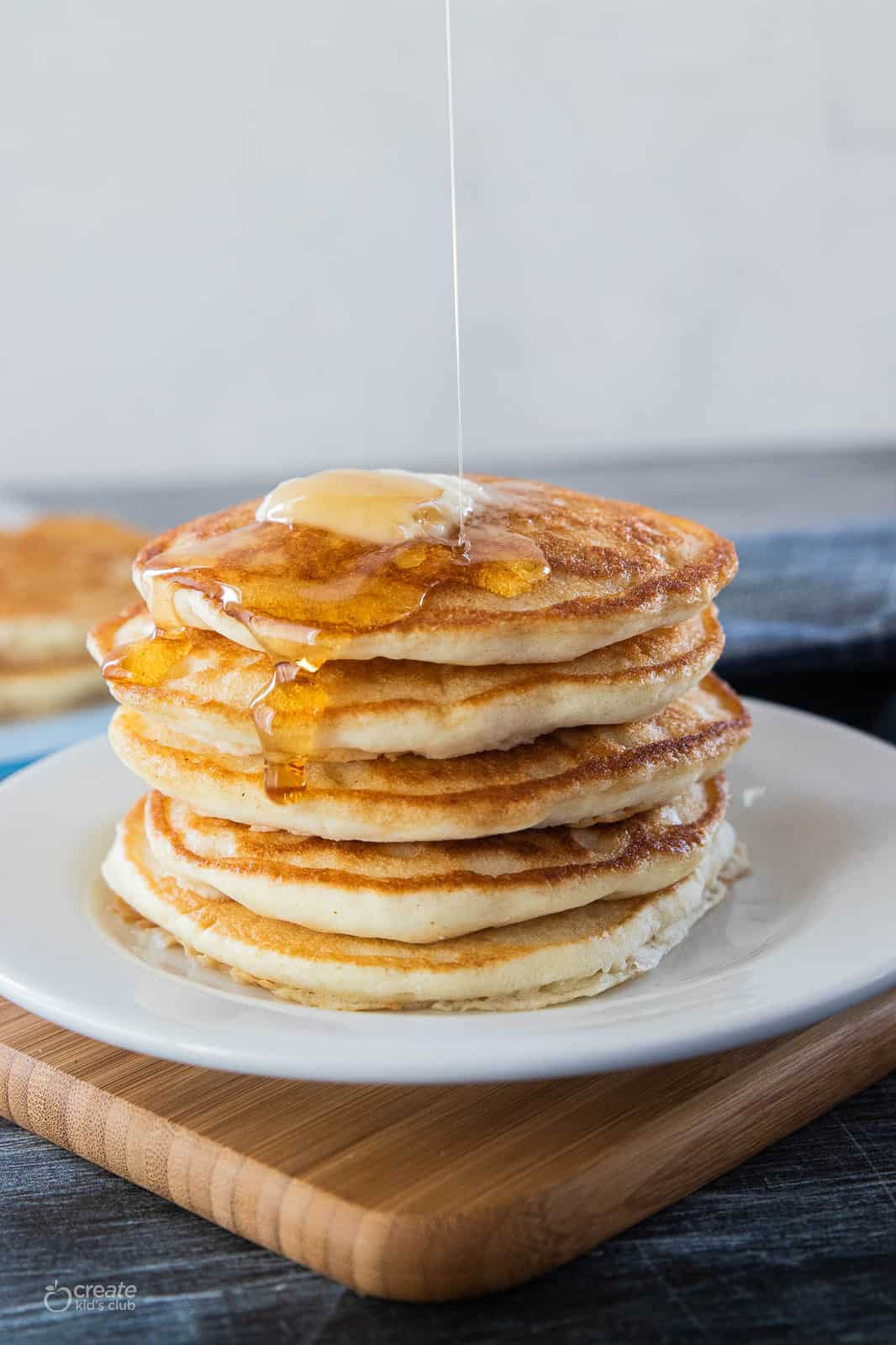 pancakes on plate with syrup and butter