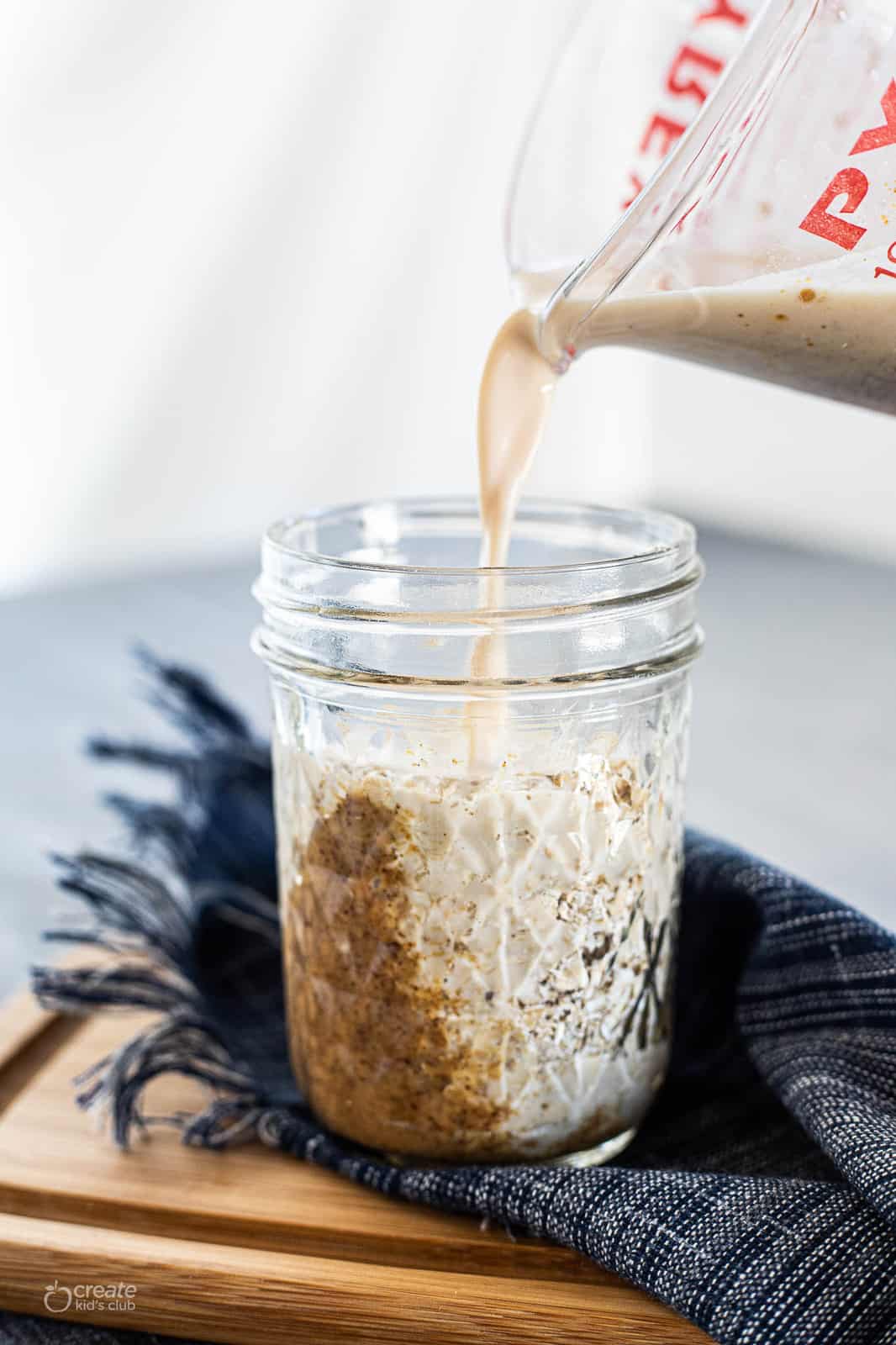 milk poured into a mason jar with peanut butter