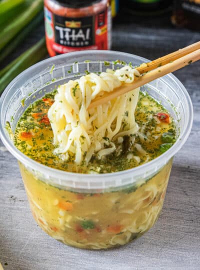 chopsticks removing ramen noodles from container