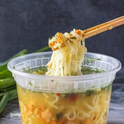 chopsticks removing ramen noodles from container