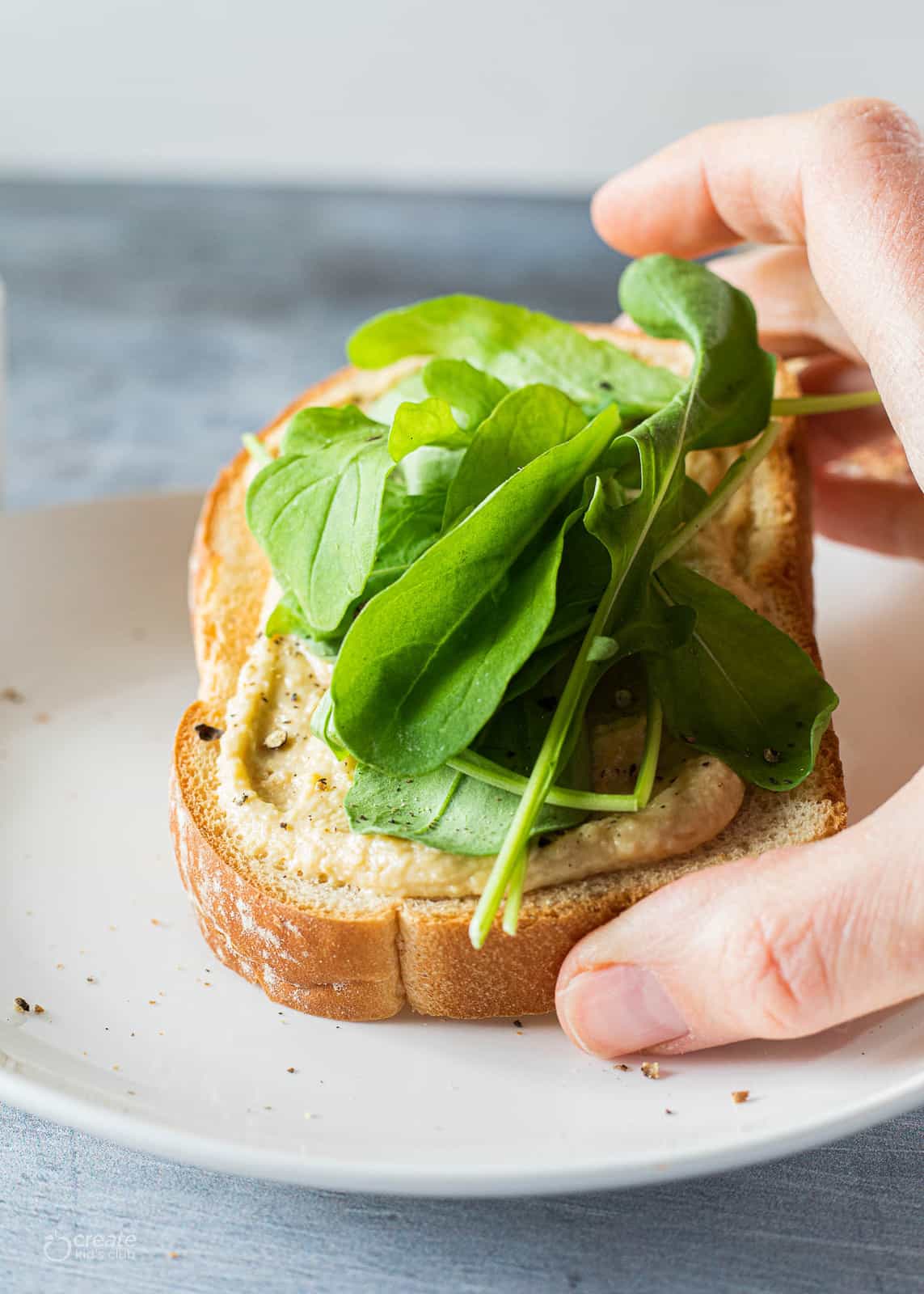 hummus and arugula on toast