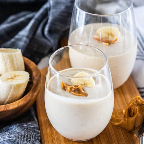 peanut butter banana smoothie in drinking glasses
